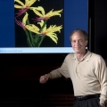 Ray Kurzweil with a computer generated painting by 'Ray Kurzweil's Cybernetic Artist'